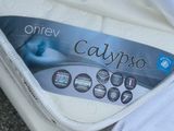 a box of calypso mattresses sitting on the ground