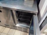 stainless steel counter top with open door in a commercial kitchen