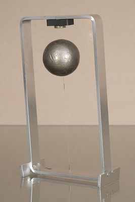 a metal ball sitting on a stand on a table