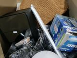 a box full of items that include a laptop, a cell phone, a hat, and other items