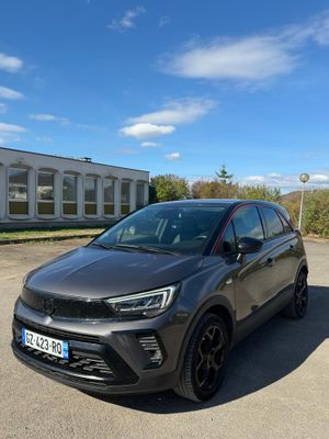 a grey car parked in a parking lot next to a building