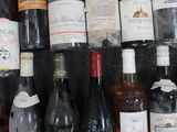 many bottles of wine sitting on a shelf in a room