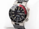 a black watch with a red bezel on it