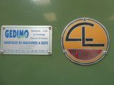 two signs on the wall of a machine shop