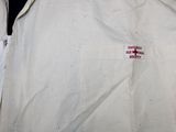 a white shirt with a red cross patch on it
