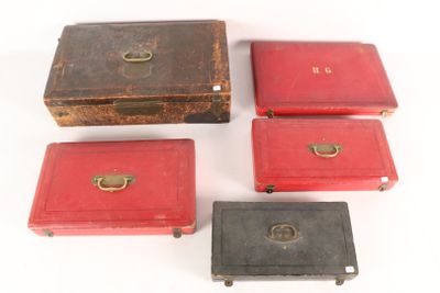 six red and black boxes with brass handles on a white surface