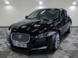the black jaguar is parked in a large room with a checkered floor