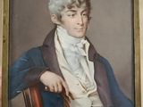 portrait d'un homme vêtu d'un manteau bleu et d'une chemise blanche, assis sur une chaise