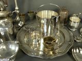 a silver tray with silverware on it on a table
