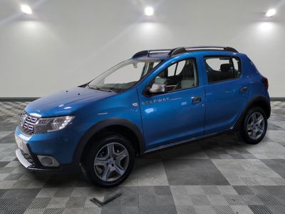 the blue dacia is parked in a room with a checkered floor