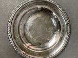 silver plate with beaded edge on a table top