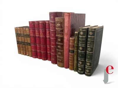 several old books stacked on top of each other on a white surface