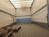 a room with a lot of wooden benches in it