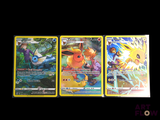 three pokemon cards sitting on top of each other on a table