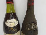 two bottles of wine sitting next to each other on a table