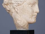 a close up of a sculpture of a woman ' s head on a table
