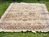 un tapis posé sur l'herbe dans le jardin par une journée ensoleillée