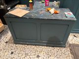 a kitchen island with a marble counter top in the middle of a kitchen