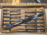 many knives and knives in a case on the table