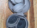 a pair of headphones in a case on a wooden floor