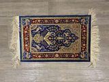 a close up of a rug on a wooden floor