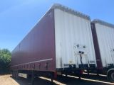 a semi trailer that is parked on the side of the road