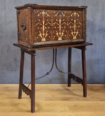 an old wooden chest sitting on top of a wooden table