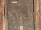 an old wooden frame with a picture of a bird on it