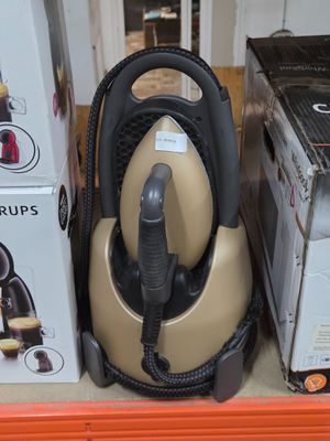 a vacuum that is sitting on a shelf next to a box