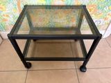 a glass table with a metal frame and a glass top