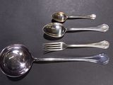 five spoons and two spoons sitting on a table