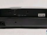 a close up of a small black device on a white surface