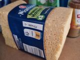 a loaf of bread sitting on a counter next to a bottle of cleaner