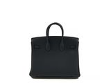 a black leather handbag on a white background