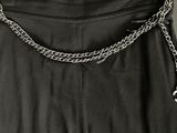 a close up of a black skirt with a chain around the waist