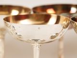 four wine glasses sitting next to each other on a table