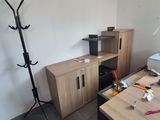 a desk with a printer and a cabinet in the corner