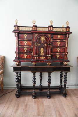 a wooden table with a red and gold design on it
