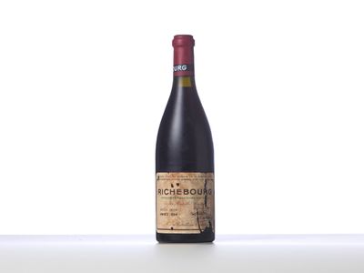 a bottle of red wine sitting on top of a table