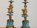 pair of antique brass candlesticks with blue and gold decoration