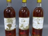 trois bouteilles de vin posées l'une à côté de l'autre sur une table