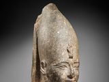 a stone head of a man wearing a helmet