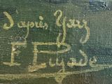 someone is writing on the side of a green box with writing on it