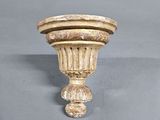 a white vase with a brown stripe on it