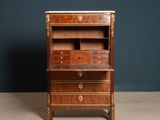 an old wooden desk with a marble top and drawers