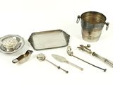 several silverware items including a silver tray, spoons and a silver plate