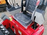 a picture of a red tractor with a seat on it ' s back