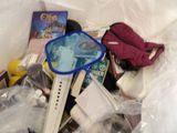 a pile of items in a plastic bag on a bed
