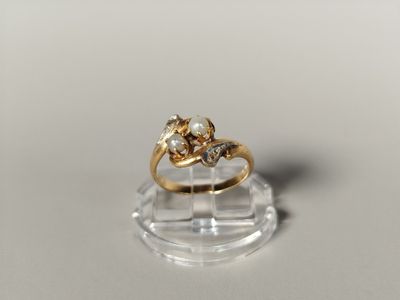 an image of a gold ring with two diamonds on top of a clear base