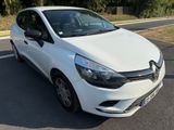 the white car is parked on the side of the road